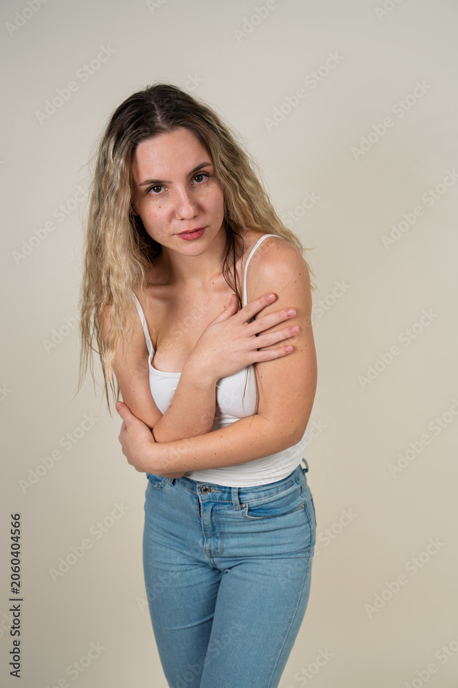 Fototapeta premium Young woman embracing her body feeling vulnerable and insecure