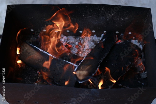 Charcoal fire burning in a rectangular outdoor barbecue grill