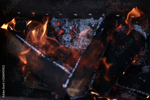 Charcoal fire burning in a rectangular outdoor barbecue grill