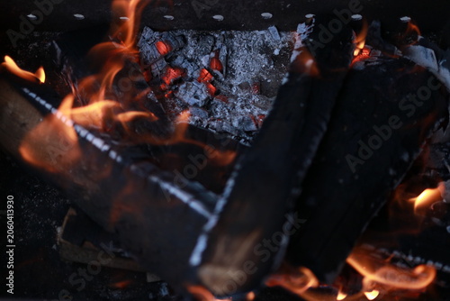 Charcoal fire burning in a rectangular outdoor barbecue grill