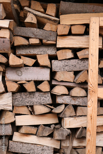 Natural firewood pile prepared for fireplace or grill