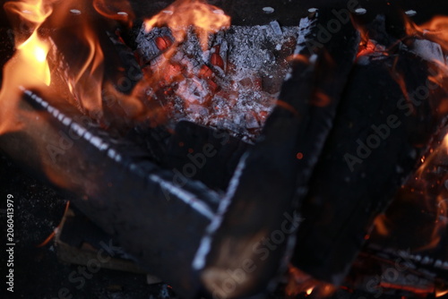 Bright barbecue fire with smoke and burning wooden logs