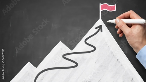 Hand drawing a mountain with a red flag on top as a symbol of business success