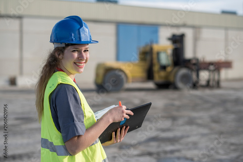 Female construction worker looking at camera and smiling in outdoors image. Cordoba, Spain.