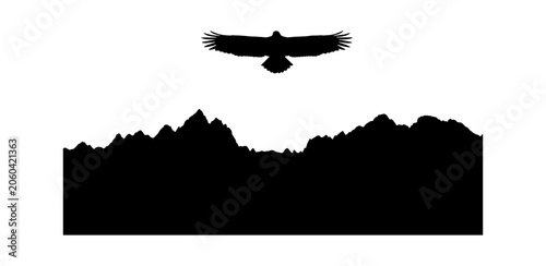 Black silhouette of a wild eagle flying high above a jagged mountain range landscape representing freedom nature adventure travel wildlife and outdoor exploration