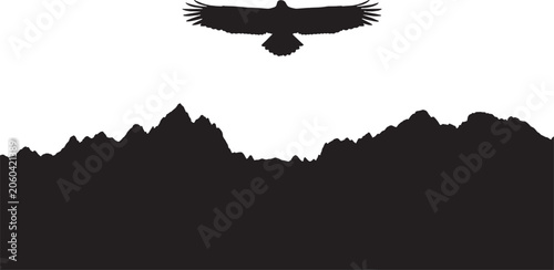 Black silhouette of a wild eagle flying high above a jagged mountain range landscape representing freedom nature adventure travel wildlife and outdoor exploration