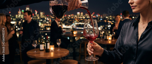 Service de vin rouge en terrasse lors d'une soirée avec vue sur la ville