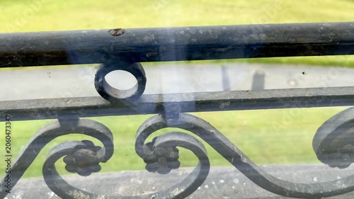 ornate railing seen through the window of a historic building