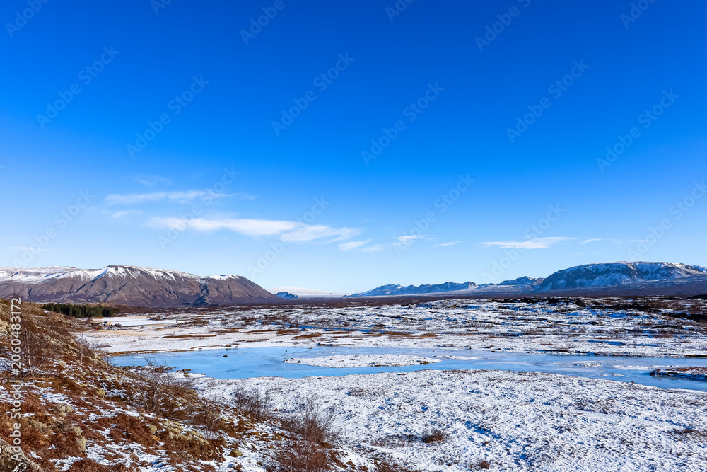 Fototapeta premium Beautiful and blue Icelandic winter landscape near Reykjavík at Thingvellir National Park, Iceland. 