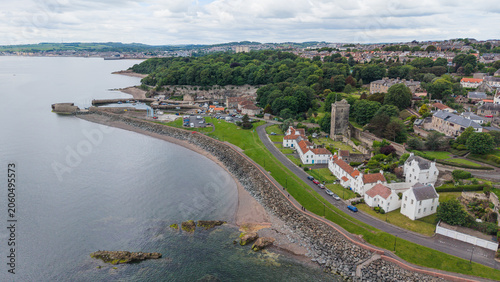 Fotografie Panoramic view of Dysart historic coastal village with traditional architecture, St Serf's Tower, and the rocky shoreline of the Firth of Forth in Fife, Scotland