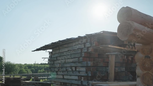 Warehouse of wooden beams for the construction of a wooden house