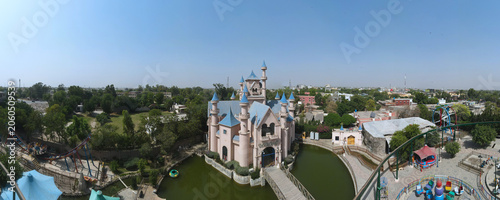 A 180-degree aerial wide-angle panorama of an amusement park.