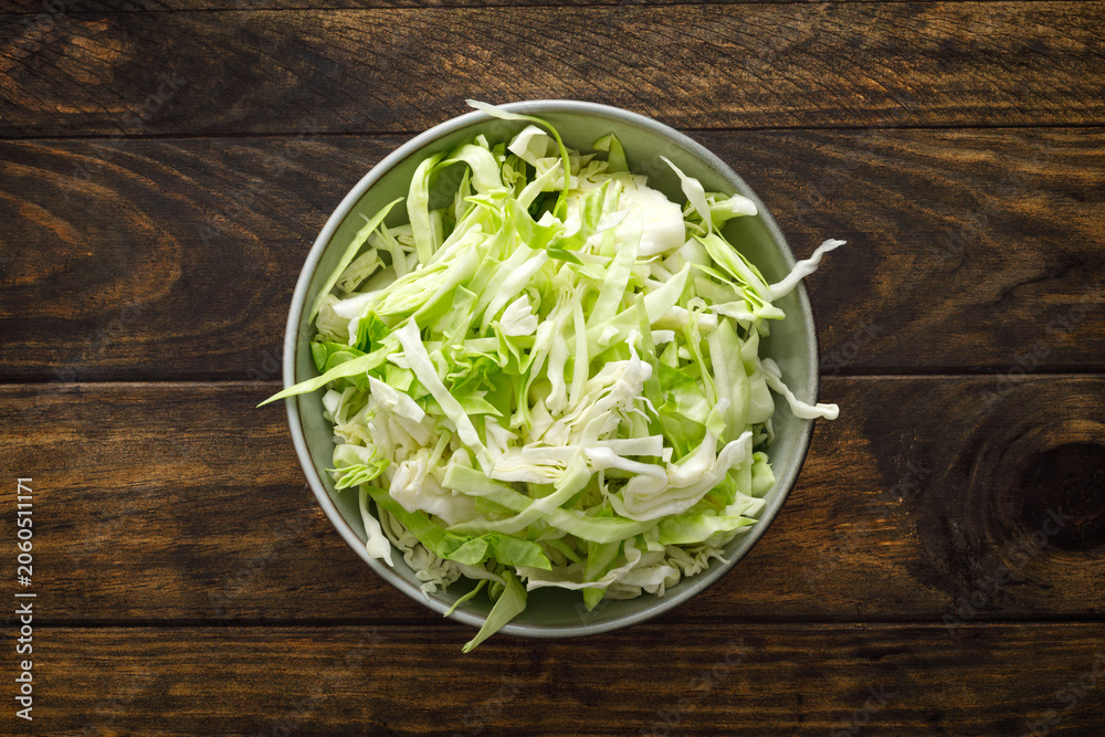 Obraz premium Cabbage cut and shredded. Fresh raw white chopped Cabbage