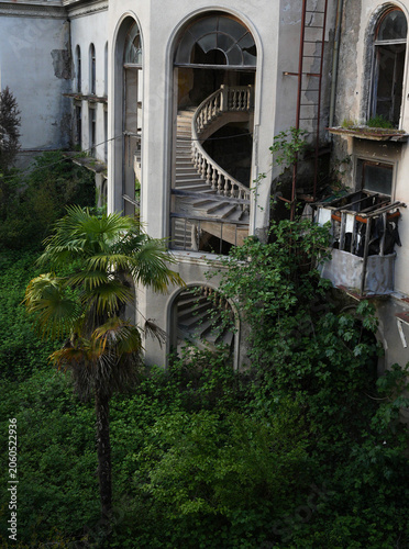 Abandoned Mansion Overtaken by Nature with Grand Spiral Staircase