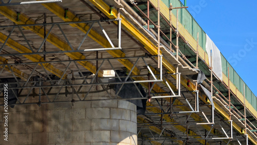 Fotografie Steel scaffolding framework built under a concrete bridge deck for restoration w