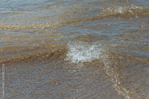 Foam from the waves on the seashore.