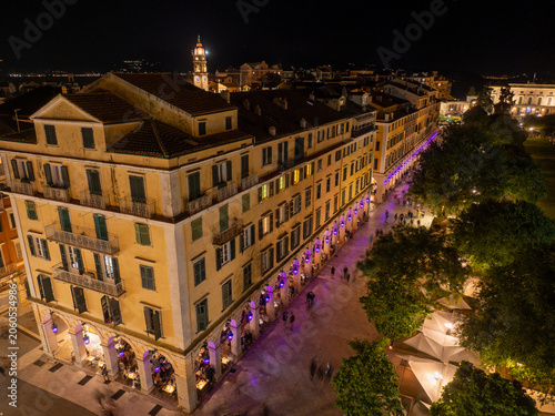 Aerial night view of the famous Liston promenade and Spianada Square with traditional Easter purple lighting in historic Corfu Old Town, Greece