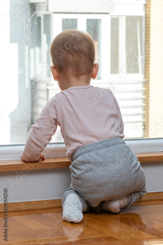 Fotografija Baby gazes longingly through window, eager for an outdoor adventure