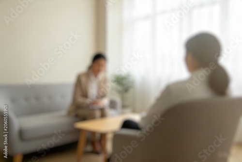 Blurred psychotherapy session in a modern office representing mental wellness, support, and healing.