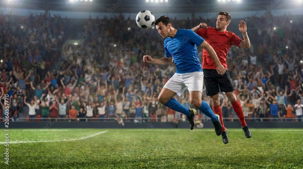 Naklejka premium Two soccer players in a fierce competition, jumping to head the ball during a match in a packed stadium. One player is in a blue uniform, the other in red