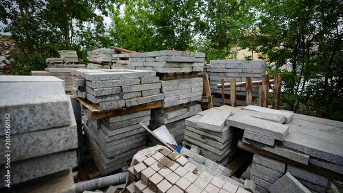 Stacks of concrete paving slabs and blocks stored at outdoor construction materials yard