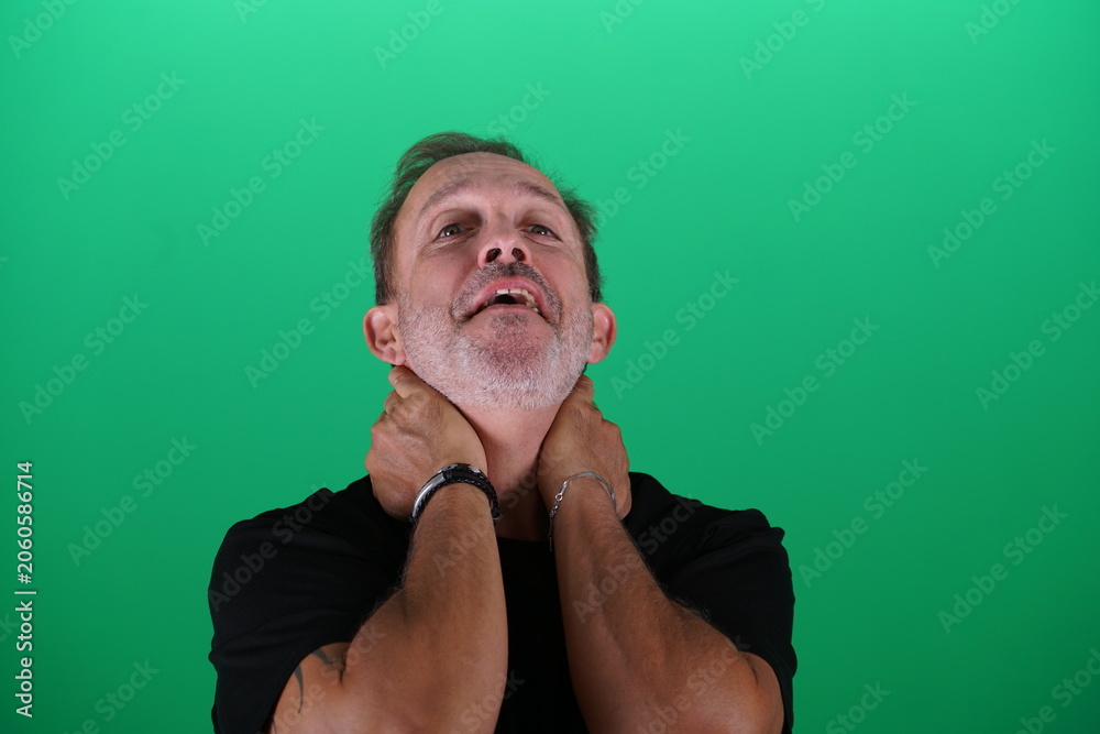 Fototapeta premium Real people. Man at his 50s, Close up shot, isolated on green screen in various poses and facial expressions. Studio capture with clean chroma key background, ideal for compositing