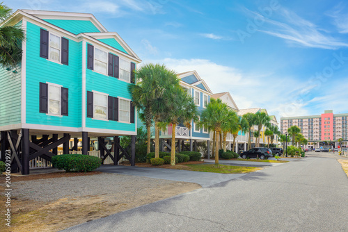 Photography Colorful seaside homes raised on stilts to resist flooding along the Grand Strand Atlantic coastline at the oceanfront resort town of Surfside Beach, South Carolina, near Myrtle Beach