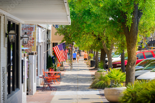 Pedestrians enjoy a sunny day at Harborwalk on Front Street in the early American city of Georgetown, South Carolina, in the Southern USA.
