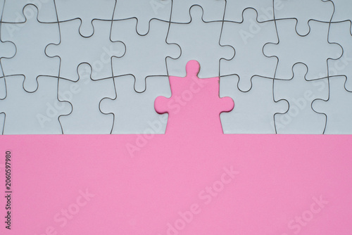 Fotografie Missing puzzle piece on coloured background