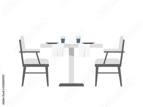 Elegant dining table set for two with chairs and place settings, ready for a meal.