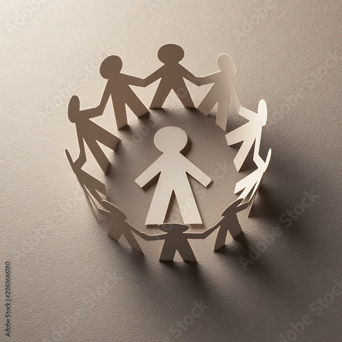 Paper people chain forming a circle with one person in the center, symbolizing community, teamwork, and inclusion.