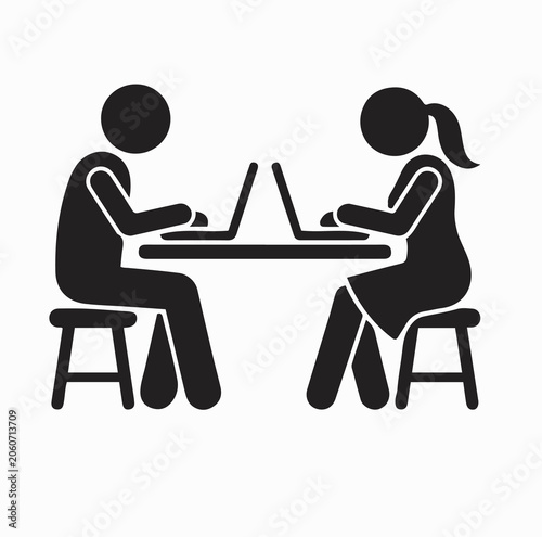 man and woman working on laptops side by side