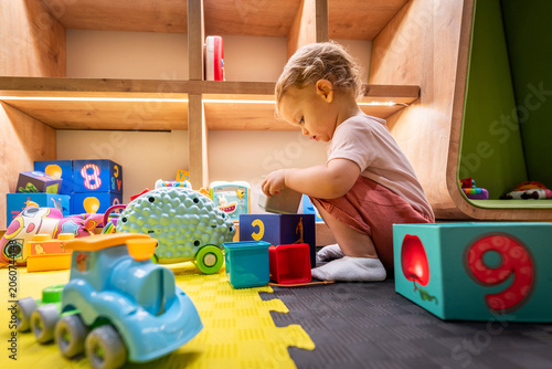 Child discovering colorful blocks and playful toys in a bright and inviting play space