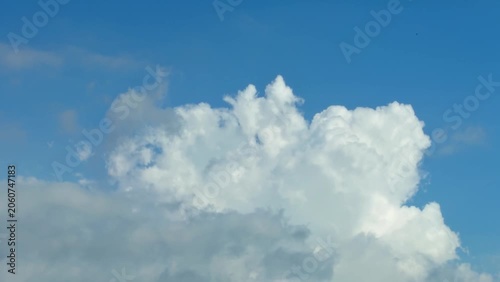 Fluffy White Clouds Floating in Bright Blue Sky with Soft Light