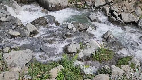 Flowing Mountain Stream Over Rocky Terrain in Natural Wilderness Setting