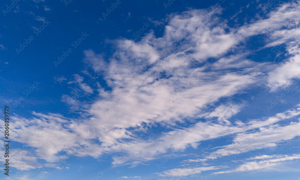 Naklejka premium Clouds sky background blue texture. Bright soft clouds white pattern. Daytime clouds wallpaper backdrop. Clouds cloudscape skyscape.