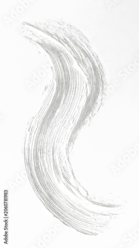 A flowing, textured silver brushstroke against a black background