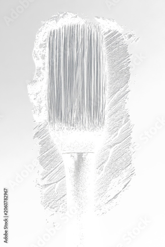 Illustration of a paintbrush, rendered with textured grey strokes, on a black background