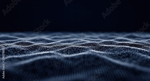 Abstract digital terrain composed of glowing blue and white particles forming undulating wave patterns on a dark navy background with shallow depth of field and bokeh effect.