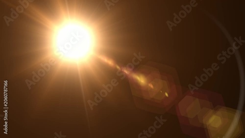 Abstract bright light burst with optical lens flare,Bright explosion of fire and light in a starry night sky with a optical lens flare.