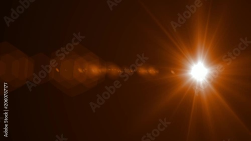 Abstract bright light burst with optical lens flare,Bright explosion of fire and light in a starry night sky with a optical lens flare.