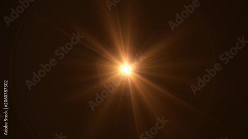 Abstract bright light burst with optical lens flare,Bright explosion of fire and light in a starry night sky with a optical lens flare.