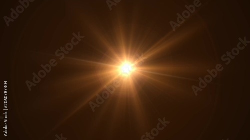 Abstract bright light burst with optical lens flare,Bright explosion of fire and light in a starry night sky with a optical lens flare.