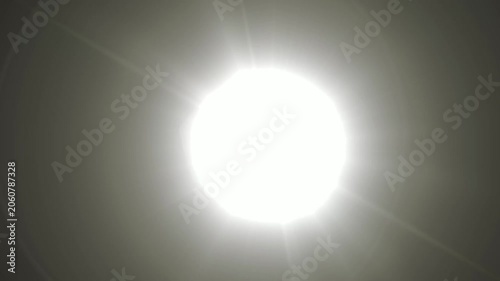 Abstract bright light burst with optical lens flare,Bright explosion of fire and light in a starry night sky with a optical lens flare.
