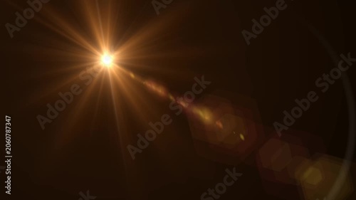 Abstract bright light burst with optical lens flare,Bright explosion of fire and light in a starry night sky with a optical lens flare.