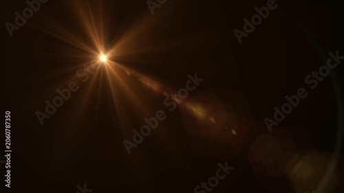 Abstract bright light burst with optical lens flare,Bright explosion of fire and light in a starry night sky with a optical lens flare.