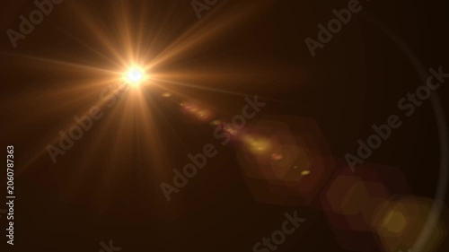 Abstract bright light burst with optical lens flare,Bright explosion of fire and light in a starry night sky with a optical lens flare.