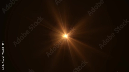 Abstract bright light burst with optical lens flare,Bright explosion of fire and light in a starry night sky with a optical lens flare.