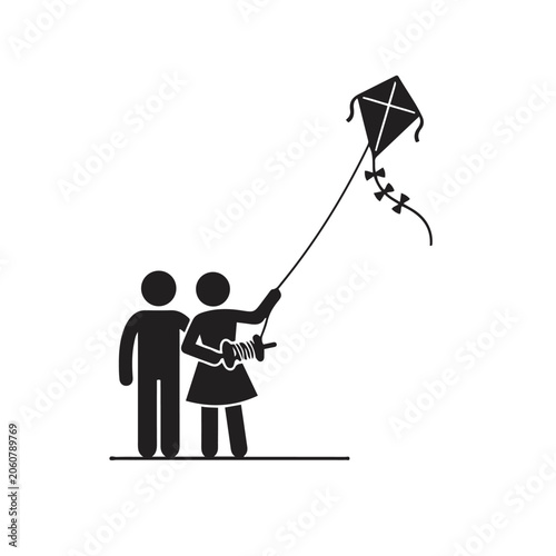 Silhouette of girl flying kite with man
