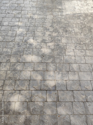 The image shows an area paved with gray stones.